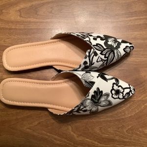 Black and white flat mules